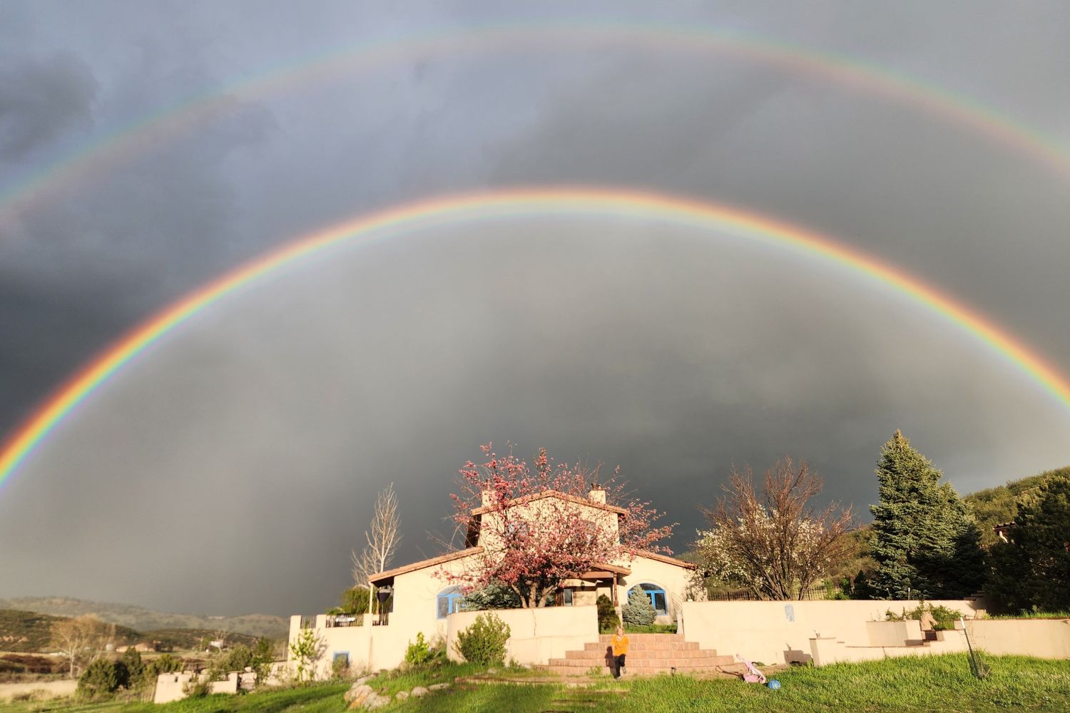 The residence under a double rainbow.